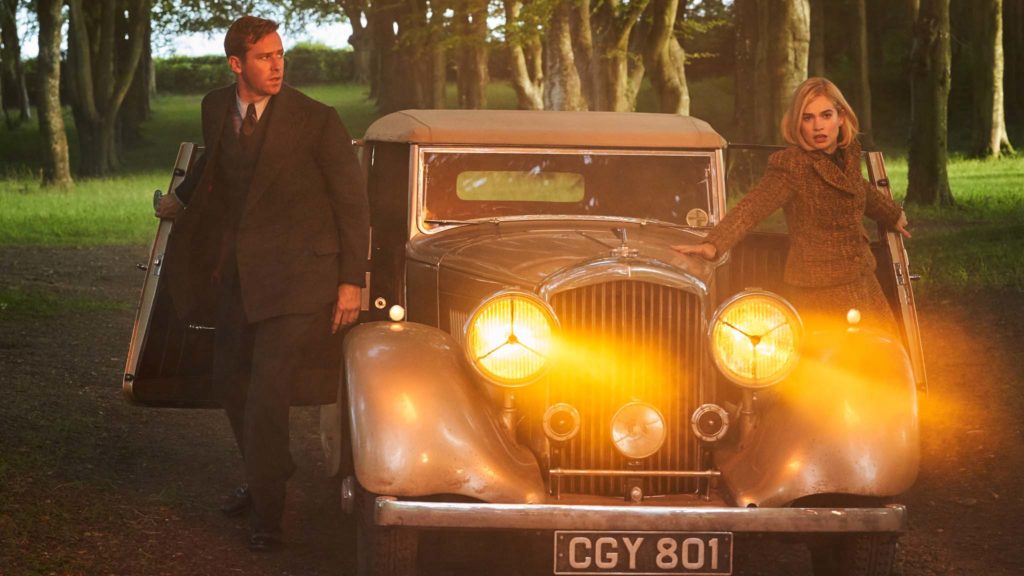 Armie Hammer as Maxim de Winter and Lily James as Mrs de Winter in Rebecca, directed by Ben Wheatley. Photo: Kerry Brown. Copyright: 2020 Netflix, Inc. All Rights Reserved.