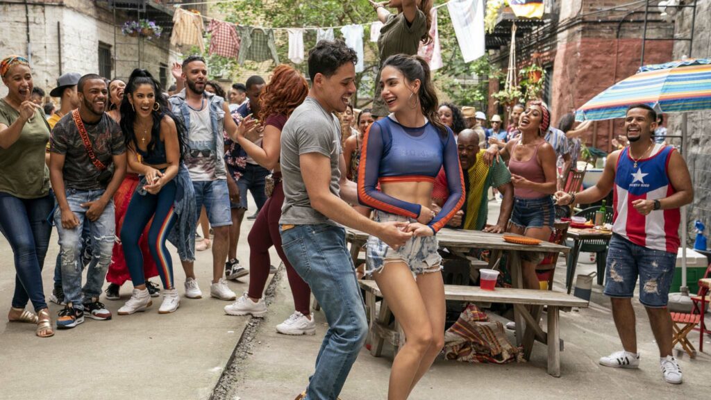 Anthony Ramos as Usnavi and Melissa Barrera as Vanessa in In The Heights, directed by Jon M Chu. Photo: Macall Polay. Copyright: 2019 Warner Bros. Entertainment Inc. All Rights Reserved.