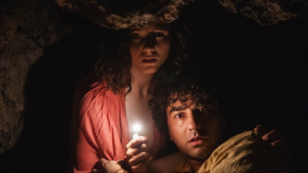 Thomasin McKenzie as Maddox and Alex Wolff as Trent in Old, directed by M Night Shyamalan. Photo: Phobymo. Copyright: 2021 Universal Studios. All Rights Reserved.