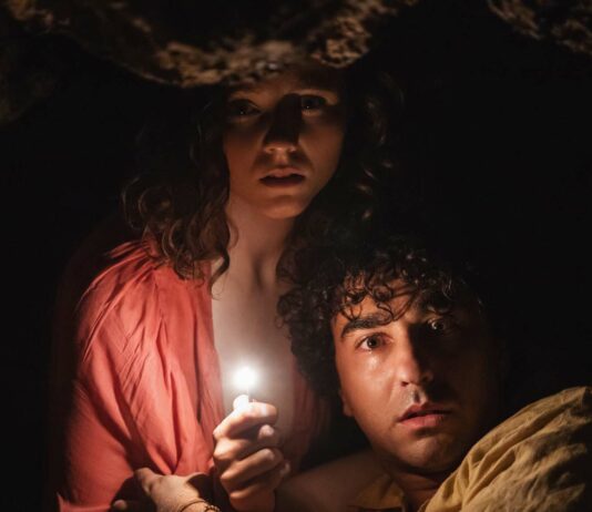 Thomasin McKenzie as Maddox and Alex Wolff as Trent in Old, directed by M Night Shyamalan. Photo: Phobymo. Copyright: 2021 Universal Studios. All Rights Reserved.