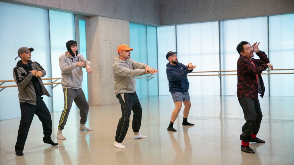 Dan Sylvester as Decoy, Steve Stamp as Steves, Allan Mustafa as MC Grindah, Hugo Chegwin as DJ Beats and Sadao Ueda as dance instructor Hiroto in People Just Do Nothing: Big In Japan, directed by Jack Clough. Photo: Guy Levy. Copyright: Focus Features/Universal Pictures. All Rights Reserved.