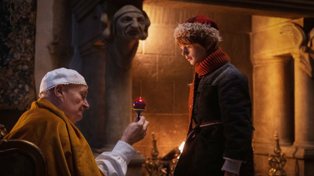 Jim Broadbent as Father Vodol and Henry Lawfull as Nikolas in A Boy Called Christmas, directed by Gil Kenan. Photo: Larry Horricks. Copyright: 2021 Netflix US, LLC/StudioCanal SAS. All Rights Reserved.