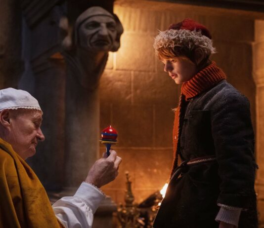 Jim Broadbent as Father Vodol and Henry Lawfull as Nikolas in A Boy Called Christmas, directed by Gil Kenan. Photo: Larry Horricks. Copyright: 2021 Netflix US, LLC/StudioCanal SAS. All Rights Reserved.