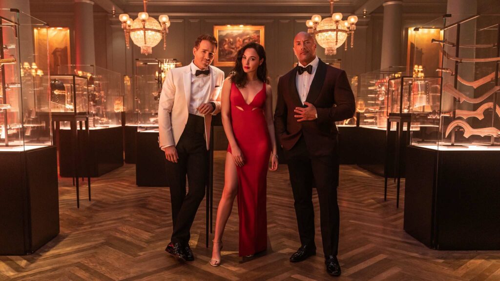 Ryan Reynolds as Nolan Booth, Gal Gadot as The Bishop and Dwayne Johnson as John Hartley in Red Notice, directed by Rawson Marshall Thurber. Photo: Frank Masi. Copyright: 2021 Netflix, Inc. All Rights Reserved.