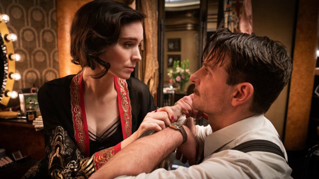 Rooney Mara as Mary Elizabeth Cahill and Bradley Cooper as Stanton Carlisle in Nightmare Alley, directed by Guillermo del Toro. Photo: Kerry Hayes. Copyright: 20th Century Studios. All Rights Reserved.
