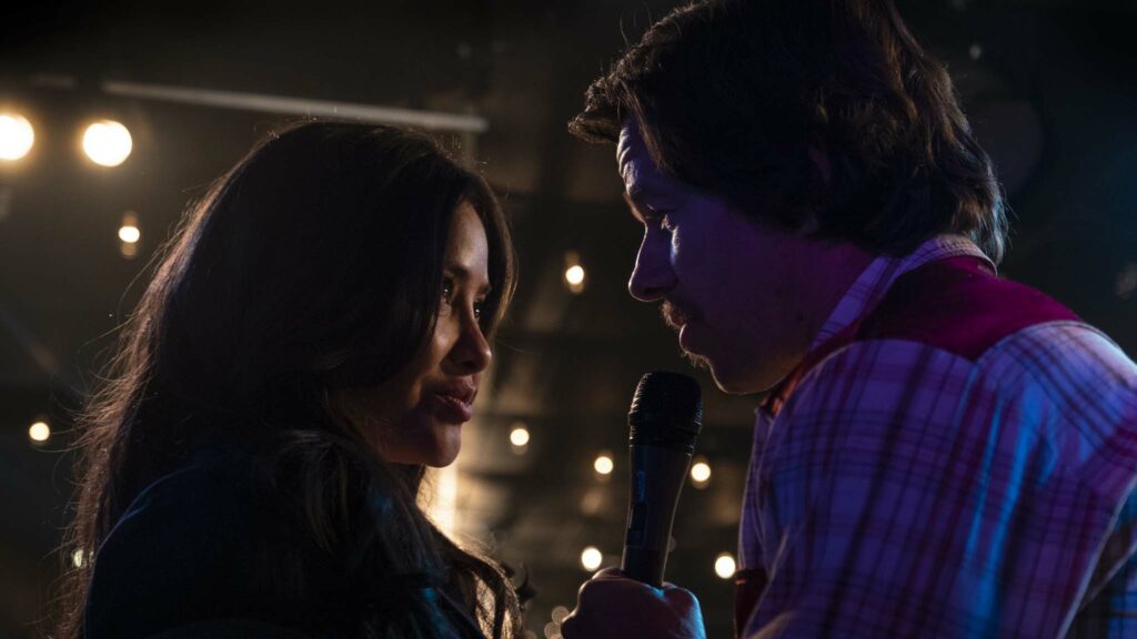 Teresa Ruiz as Carmen and Mark Wahlberg as Father Stuart 