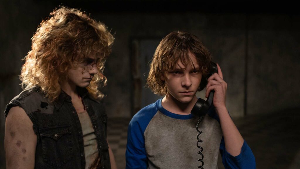 Brady Hepner as Vance Hopper and Mason Thames as Finney Shaw in The Black Phone, directed by Scott Derrickson. Photo: Fred Norris. Copyright: 2022 Universal Studios. All Rights Reserved.