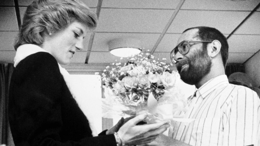 The Princess of Wales is presented with a bouquet by AIDS patient Martin Johnson during her visit to the Mildmay Mission Hospital AIDS Hospice in East London. Copyright: PA Archive/PA Images. All Rights Reserved.