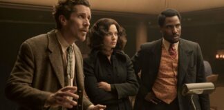 Christian Bale as Burt Berendsen, Margot Robbie as Valerie and John David Washington as Harold Woodman in Amsterdam, directed by David O Russell. Photo: Merie Weismiller Wallace/SMPSP. Copyright: 20th Century Studios. All Rights Reserved.