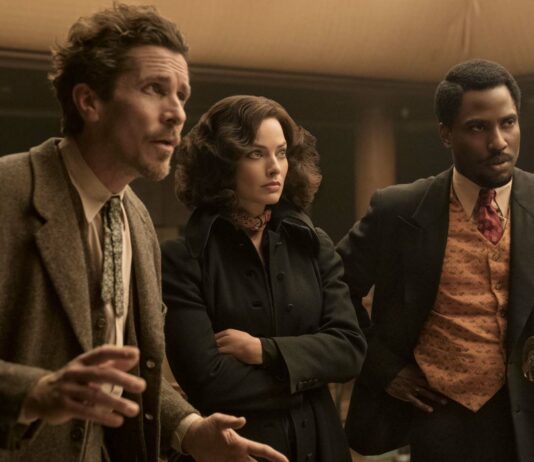 Christian Bale as Burt Berendsen, Margot Robbie as Valerie and John David Washington as Harold Woodman in Amsterdam, directed by David O Russell. Photo: Merie Weismiller Wallace/SMPSP. Copyright: 20th Century Studios. All Rights Reserved.