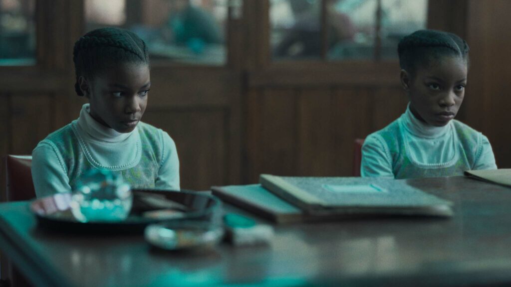 Leah Mondesir Simmons as June Gibbons and Eva-Arianna Baxter as Jennifer Gibbons in The Silent Twins, directed by Agnieszka Smoczynska. Photo: Jakub Kijowski. Copyright: 2022 Focus Features, LLC. All Rights Reserved.