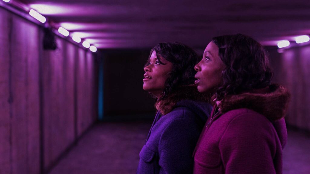 Letitia Wright as June Gibbons and Tamara Lawrance as Jennifer Gibbons in The Silent Twins, directed by Agnieszka Smoczynska. Photo: Lukasz Bak. Copyright: 2022 Focus Features, LLC. All Rights Reserved.