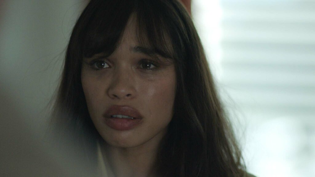 Cleopatra Coleman as Em Foster in Infinity Pool, directed by Brandon Cronenberg. Copyright: Universal Pictures. All Rights Reserved.