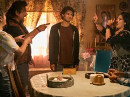 Elpidia Carrillo as Rocio, George Lopez as Uncle Rudy, Xolo Mariduena as Jaime Reyes, Belissa Escobedo as Milagro and Damian Alcazar as Alberto in Blue Beetle, directed by Angel Manuel Soto. Photo: Hopper Stone/SMPSP. Copyright: Warner Bros. Entertainment Inc. All Rights Reserved.