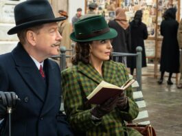 Kenneth Branagh as Hercule Poirot and Tina Fey as Ariadne Oliver in A Haunting In Venice, directed by Kenneth Branagh. Photo: Rob Youngson. Copyright: 20th Century Studios. All Rights Reserved.