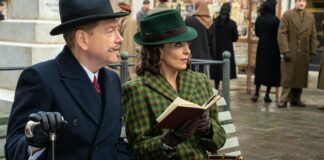 Kenneth Branagh as Hercule Poirot and Tina Fey as Ariadne Oliver in A Haunting In Venice, directed by Kenneth Branagh. Photo: Rob Youngson. Copyright: 20th Century Studios. All Rights Reserved.