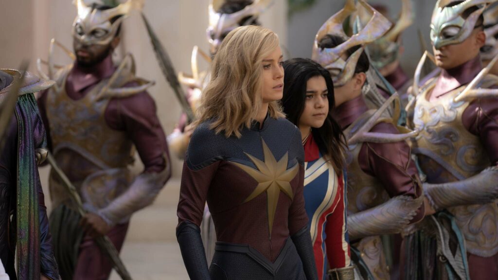 Brie Larson as Captain Marvel/Carol Danvers and Iman Vellani as Ms. Marvel/Kamala Khan in The Marvels, directed by Nia DaCosta. Photo: Laura Radford. Copyright: Marvel. All Rights Reserved.