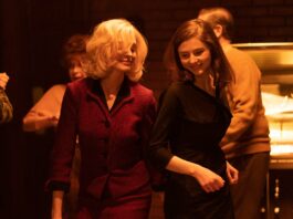 Anne Hathaway as Dr Rebecca St John and Thomas McKenzie as Eileen Dunlop in Eileen, directed by William Oldroyd. Photo: Jeong Park. Copyright: Universal Pictures. All Rights Reserved.
