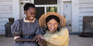 Phylicia Pearl Mpasi as Young Celie and Halle Bailey as Young Nettie in The Color Purple, directed by Blitz Bazawule. Copyright: Warner Bros. Entertainment Inc. All Rights Reserved.