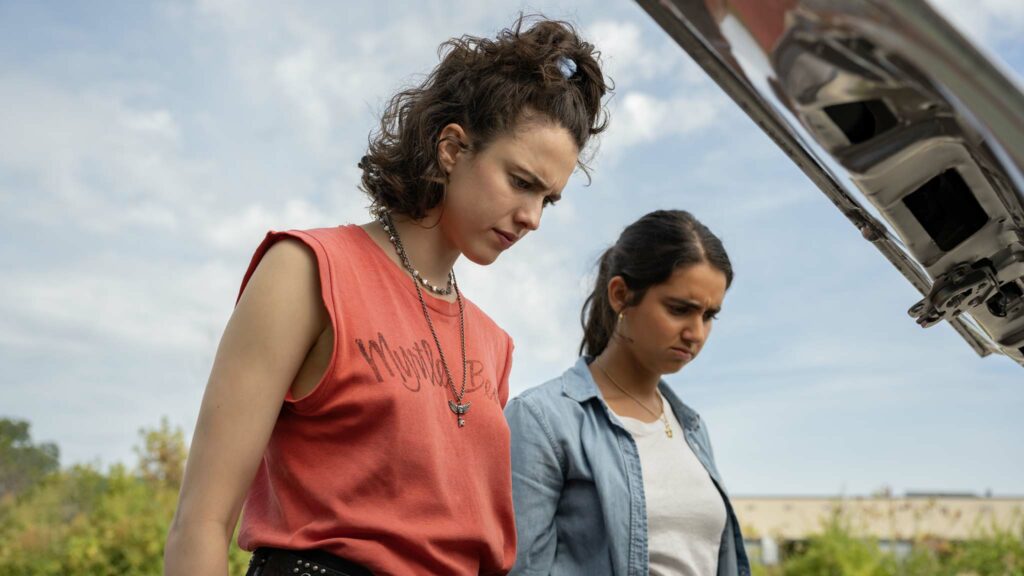 Margaret Qualley as Jamie and Geraldine Viswanathan as Marian in Drive-Away Dolls, directed by Ethan Coen. Photo: Wilson Webb. Copyright: Working Title/Focus Features. All Rights Reserved.