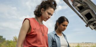 Margaret Qualley as Jamie and Geraldine Viswanathan as Marian in Drive-Away Dolls, directed by Ethan Coen. Photo: Wilson Webb. Copyright: Working Title/Focus Features. All Rights Reserved.