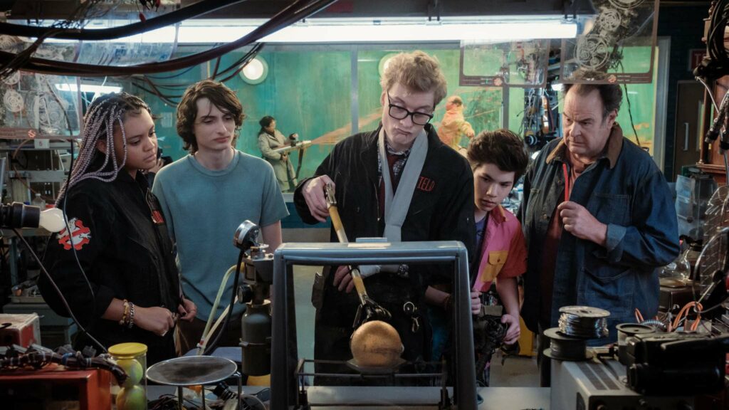 Celeste O’Connor as Lucky, Finn Wolfhard as Trevor, James Acaster as Lars Pinfield, Logan Kim as Podcast and Dan Aykroyd as Ray in Ghostbusters: Frozen Empire, directed by Gil Kenan. Photo: Jaap Buitendijk. Copyright: CTMG, Inc. All Rights Reserved.