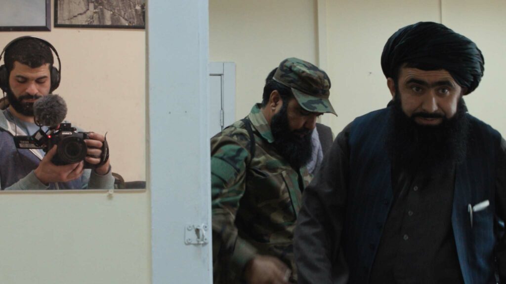 Director Ibrahim Nash'at with the Taliban at Hollywood Gate in Hollywoodgate, directed by Ibrahim Nash'at. Copyright: Curzon. All Rights Reserved.