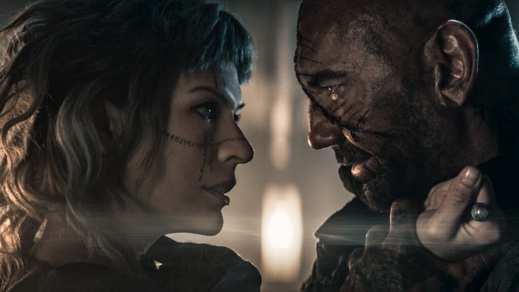 Milla Jovovich as Gray Alys and Dave Bautista as Boyce in In The Lost Lands, directed by Paul WS Anderson. Copyright: StudioCanal. All Rights Reserved.