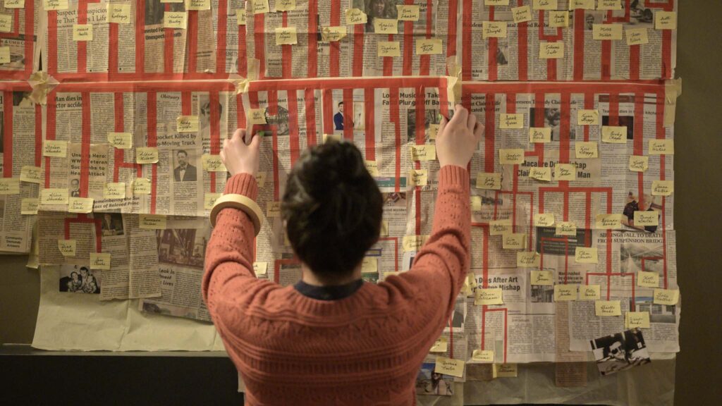 Kaitlyn Santa Juana as Stefanie scrutinises the deadly timeline in Final Destination Bloodlines, directed by Adam Stein and Zach Lipovsky. Photo: Eric Milner. Copyright: Warner Bros. Entertainment Inc. All Rights Reserved.