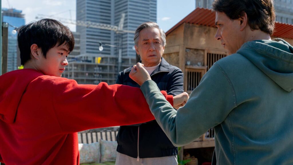 Ben Wang as Li Fong, Jackie Chan as Mr Han and Ralph Macchio as Daniel LaRusso in Karate Kid: Legends, directed by Jonathan Entwistle. Photo: Jonathan Wenk. Copyright: CTMG, Inc. All Rights Reserved.