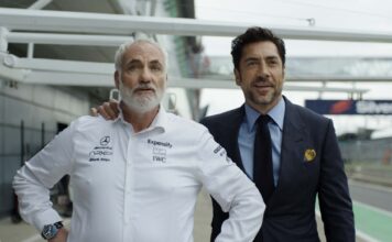 Kim Bodnia as Kaspar and Javier Bardem as Ruben Cervantes in F1: The Movie, directed by Joseph Kosinski. Copyright: Warner Bros. Entertainment Inc./Apple Original Films. All Rights Reserved.
