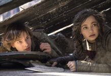 Mason Thames as Hiccup and Nico Parker as Astrid in How To Train Your Dragon, directed by Dean DeBlois. Photo: Helen Sloan. Copyright: Universal Studios. All Rights Reserved.