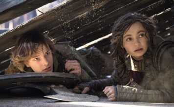 Mason Thames as Hiccup and Nico Parker as Astrid in How To Train Your Dragon, directed by Dean DeBlois. Photo: Helen Sloan. Copyright: Universal Studios. All Rights Reserved.