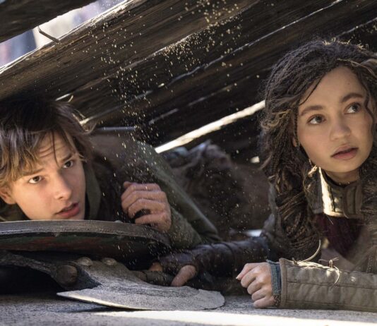 Mason Thames as Hiccup and Nico Parker as Astrid in How To Train Your Dragon, directed by Dean DeBlois. Photo: Helen Sloan. Copyright: Universal Studios. All Rights Reserved.