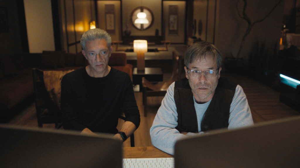 Vincent Cassel as Karsh and Guy Pearce as Maury in The Shrouds, directed by David Cronenberg. Photo: Sophie Giraud. Copyright: Vertigo Releasing. All Rights Reserved.