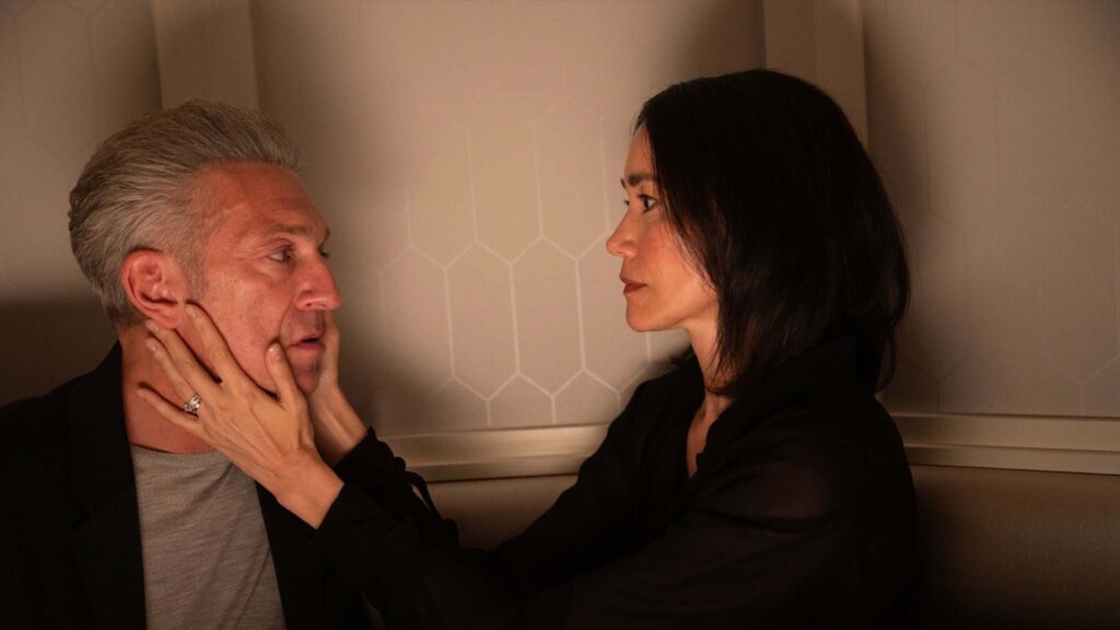 Vincent Cassel as Karsh and Sandrine Holt as Soo-Min Szabo in The Shrouds, directed by David Cronenberg. Photo: Sophie Giraud. Copyright: Vertigo Releasing. All Rights Reserved.