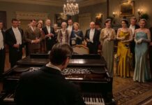 Allen Leech as Tom Branson, Dominic West as Guy Dexter, Robert James-Collier as Thomas Barrow, Douglas Reith as Lord Merton, Sarah Crowden as Lady Manville, Penelope Wilton as Isobel Merton, Paul Giamatti as Harold Levinson, Elizabeth McGovern as Cora Grantham, Michelle Dockery as Lady Mary, Hugh Bonneville as Robert Grantham, Laura Carmichael as Lady Edith and Harry Hadden-Paton as Bertie Hexham in Downton Abbey: The Grand Finale, directed by Simon Curtis. Photo: Rory Mulvey. Copyright: Focus Features LLC. All Rights Reserved.
