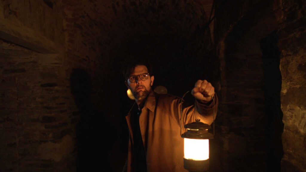 Adam Scott as Ohm Bauman in Hokum, directed by Damian McCarthy. Copyright: Black Bear. All Rights Reserved.