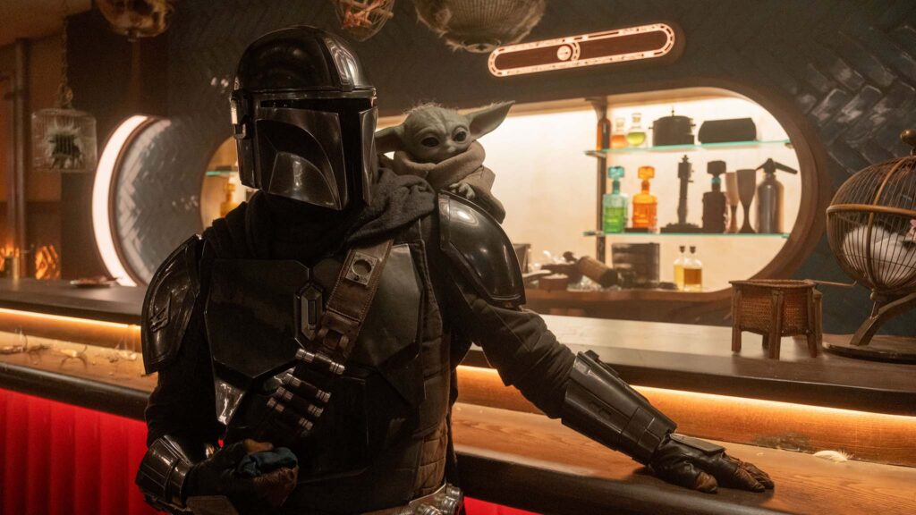 Pedro Pascal as The Mandalorian and Grogu. in Star Wars: The Mandalorian and Grogu., directed by Jon Favreau. Photo: Nicola Goode. Copyright: Lucasfilm Ltd. All Rights Reserved.