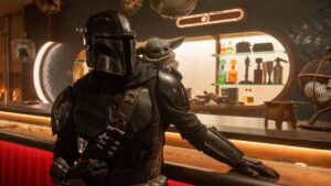Pedro Pascal as The Mandalorian and Grogu. in Star Wars: The Mandalorian and Grogu., directed by Jon Favreau. Photo: Nicola Goode. Copyright: Lucasfilm Ltd. All Rights Reserved.