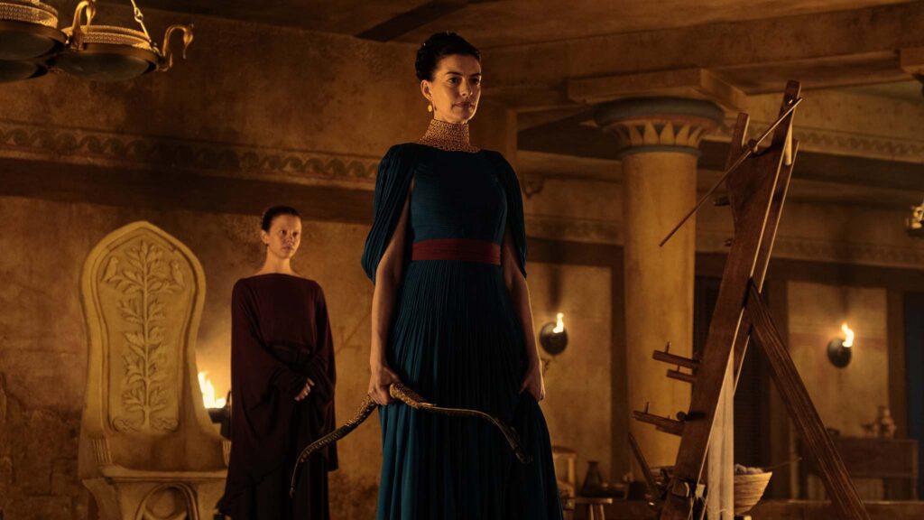 Mia Goth as Melantho and Anne Hathaway as Penelope in The Odyssey, directed by Christopher Nolan. Photo: Melinda Sue Gordon. Copyright: Universal Studios. All Rights Reserved.
