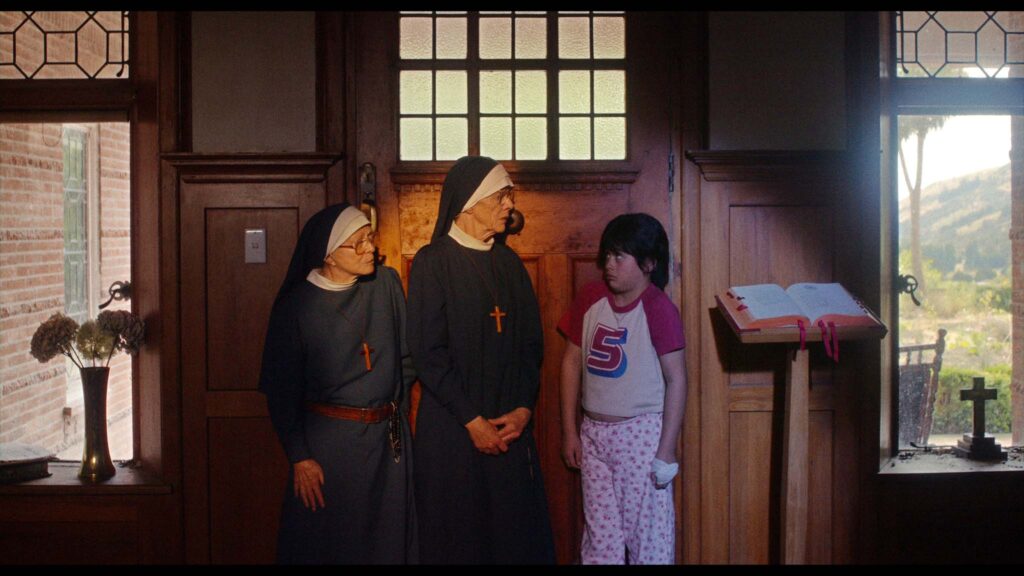 Jacki Weaver as Sister Mary Clare, Judy Davis as Sister Agnes and Elijah Tamati as Brian Collins in Holy Days, directed by Nat Boltt. Copyright: Lightbulb Distribution. All Rights Reserved.